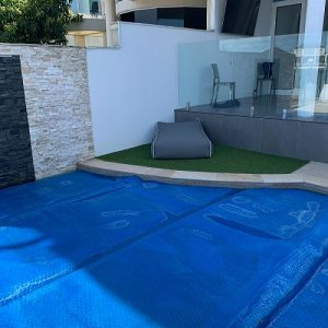 Synthetic outdoor grass mat around pool