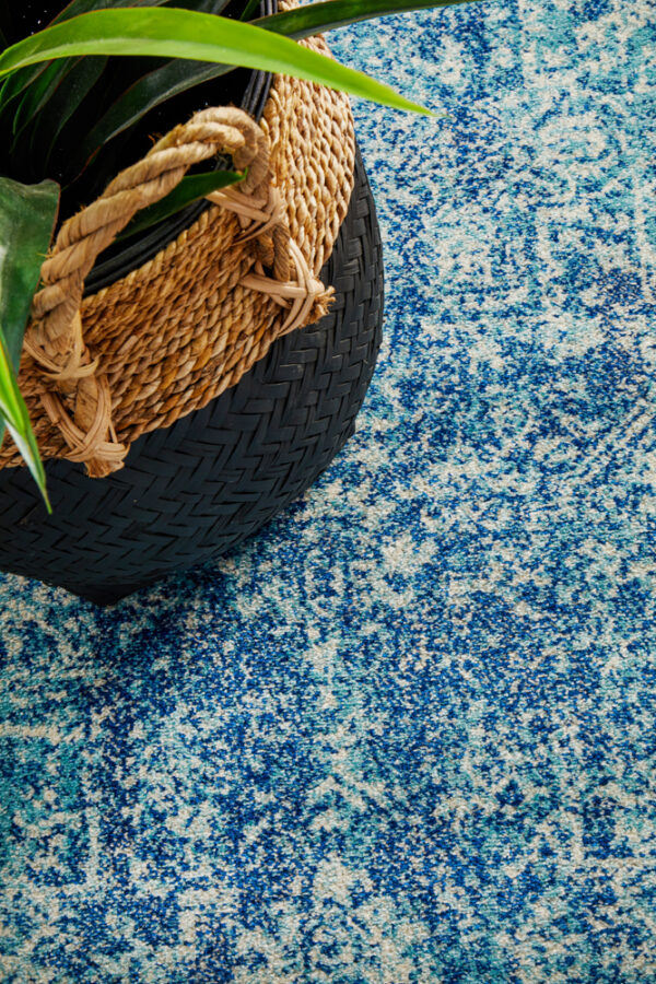 Faded Blue Area Rug runner with a pot on it