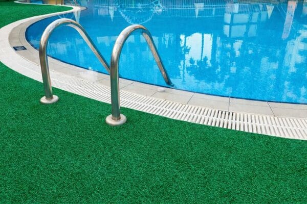Green marine carpet installed around swimming pool area in Australia